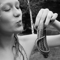 Girl kissing snake