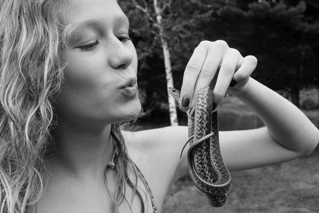 Girl kissing snake