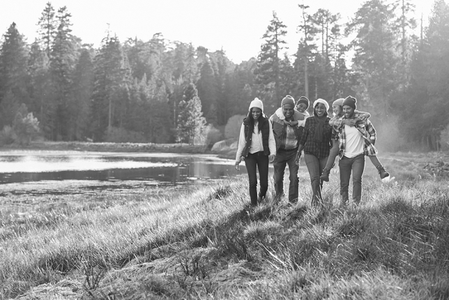 People walking outdoors by a lake